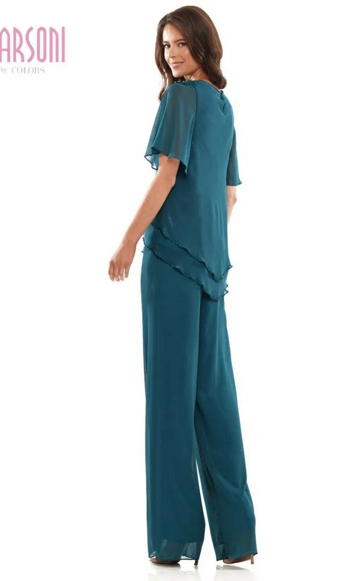A woman stands looking over her shoulder in the Marsoni M321 long formal pantsuit—a teal chiffon two-piece with short flutter sleeves, beaded edges, and a layered hem.